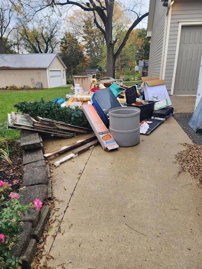 Dumpster being loaded with debris for 3 Yard Dumpster Rental in La Center